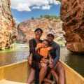 Family in a Boat Between the Rocks, During The Ultimate Summer Escape to South America & the Caribbean